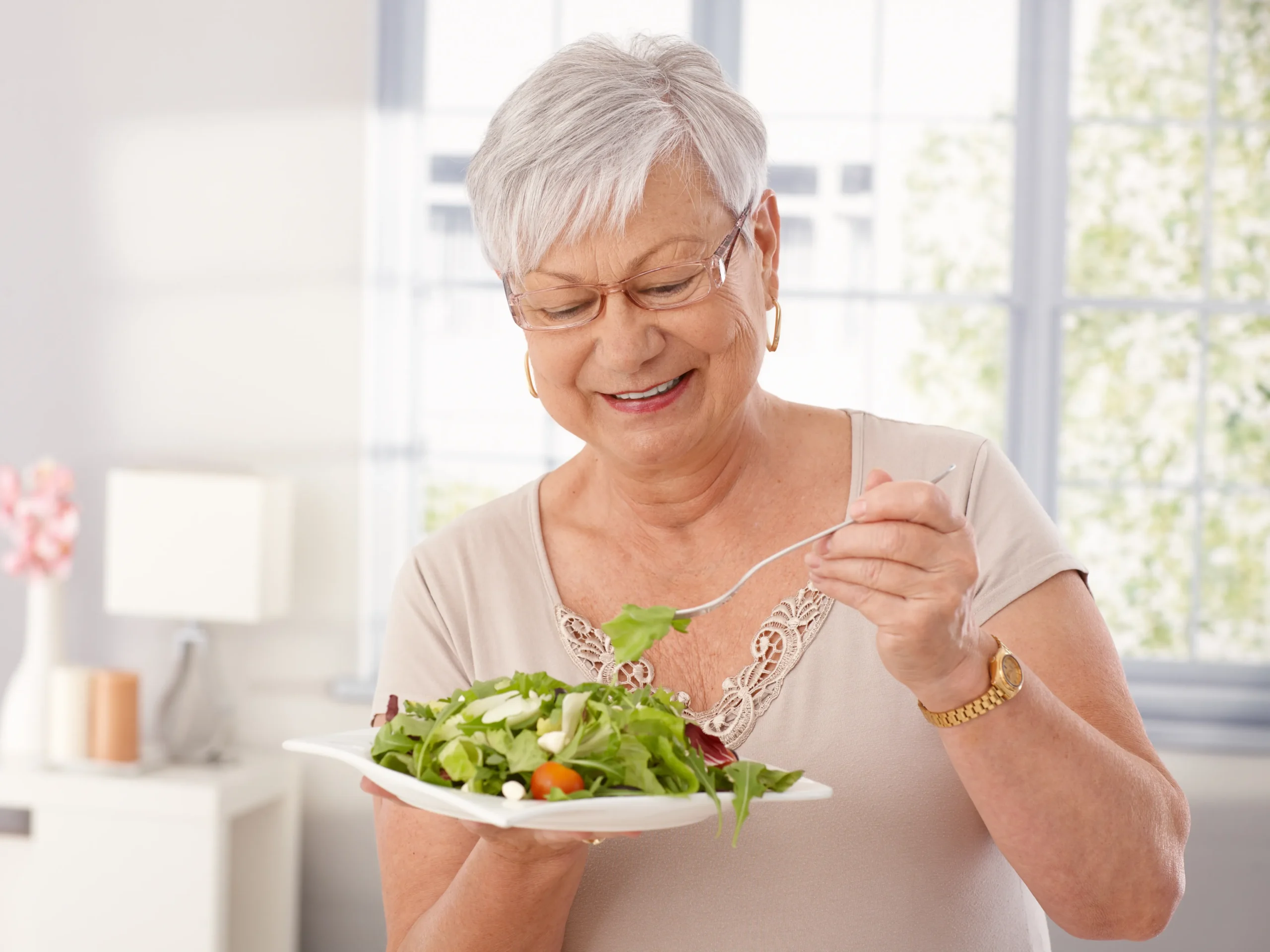 Healthy Eating Tips For Seniors - elderly woman eating a healthy salad