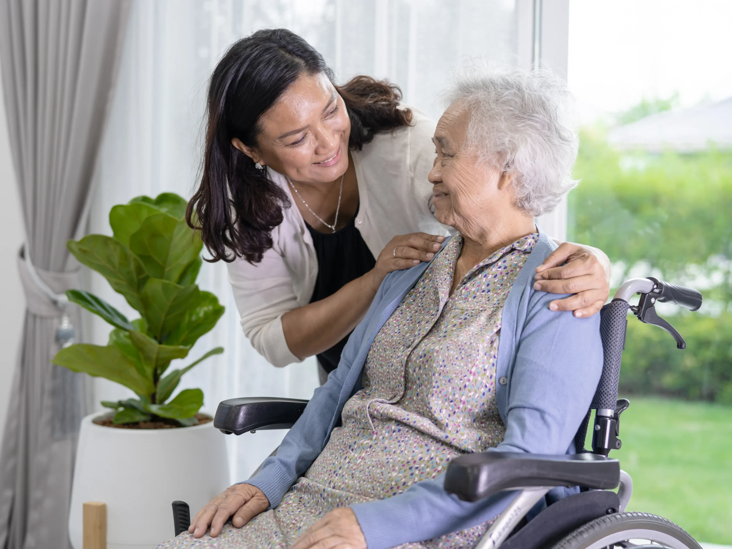 professional in-home care from woman for elderly woman in a wheel chair