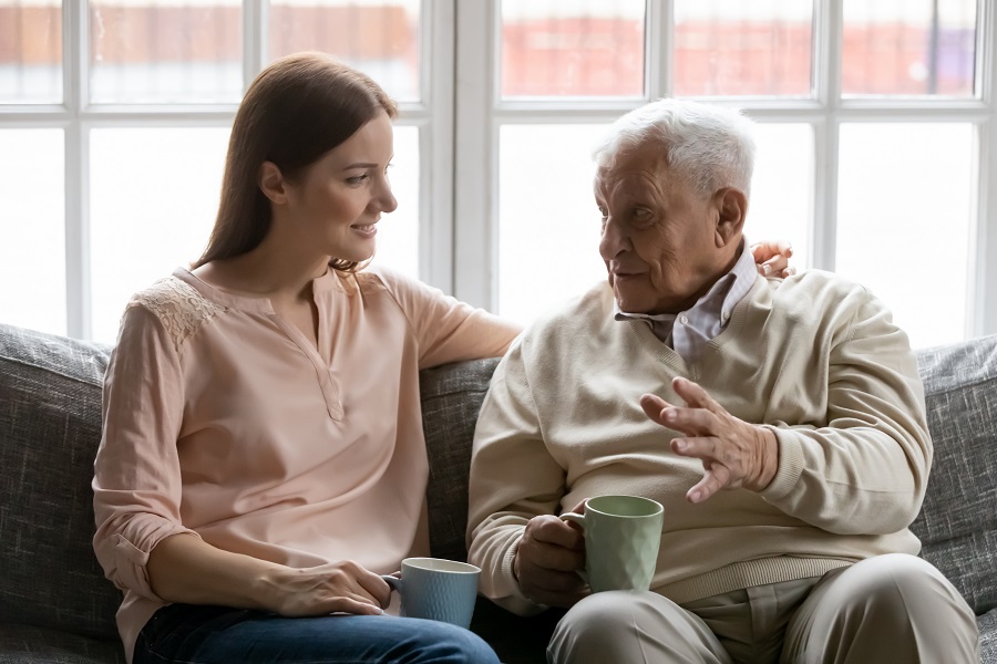 Care for aging parents - daughter sitting with elderly father having a conversation